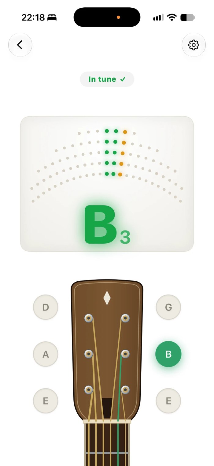 The guitar tuner in Music Folder on iPhone: the B string in tune, shown on a guitar headstock